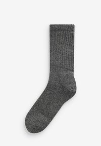 Calzino in cotone grigio con motivo a coste, lunghezza a metà polpaccio e una texture morbida. Presenta un piccolo logo sul lato.