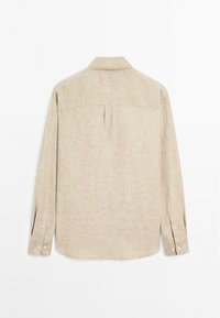 Beige long-sleeve shirt with a textured fabric, a back yoke and pleat, buttoned cuffs, and white buttons. Plain design, no patterns.