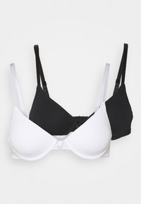 Deux soutiens-gorge empilés, un blanc et un noir. Tous deux présentent un tissu lisse, des bretelles réglables et un design simple sans ornements.