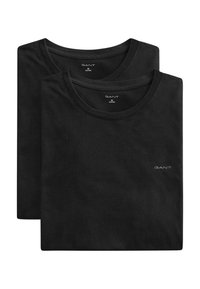 Dos camisetas negras de cuello redondo dobladas con pequeño logo de GANT en el pecho y marca en el interior del cuello, talla mediana.