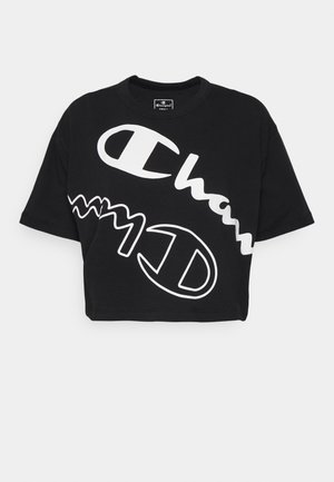 Zwarte cropped t-shirt van katoen met grote witte logo's en golvende tekstpatronen. Losse pasvorm met een ronde halslijn en korte mouwen.