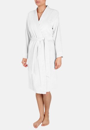 White terry cloth bathrobe featuring a tie waist, long sleeves, subtle embossed pattern, and side pockets. Knee-length design.