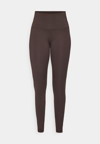 Brune højtaljede leggings lavet af et strækbart, glat materiale. Har et tætsiddende design uden synlige sømme eller mønstre.
