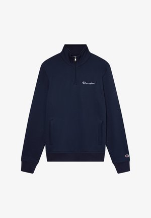 Granatowy sweatshirt z wysokim kołnierzem i półzamkiem. Posiada boczne kieszenie oraz białe haftowane logo na klatce piersiowej. Miękka tekstura materiału.