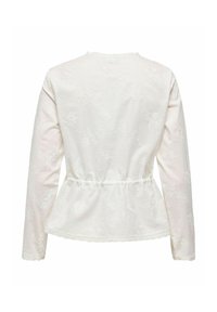 Haut blanc à manches longues avec broderie florale, taille froncée, ourlet incurvé et tissu texturé. La vue de dos met en valeur les détails délicats et la silhouette.