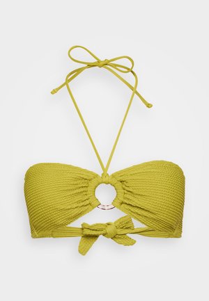 Haut de bikini style brassière en tissu texturé vert citron, présente une découpe circulaire centrale avec un anneau métallique et des liens ajustables.