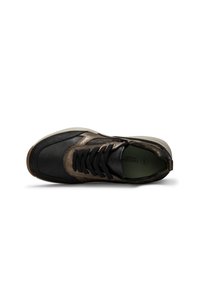 Black and brown athletic shoe with a textured leather exterior, lace closure, and a green insole, featuring a rubber sole and minimal branding.