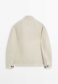 Back view of a beige long-sleeve jacket with a collar and buttoned cuffs on a white background.