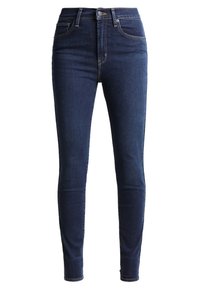 Jeans ajustados en denim azul oscuro, con una cintura alta, diseño tradicional de cinco bolsillos y detalles de costura sutiles a lo largo de las costuras.