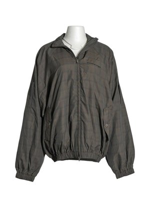 Veste légère gris foncé avec motif à carreaux subtil, fermeture éclair complète à l'avant, poches latérales boutonnées et poignets et ourlet élastiques.