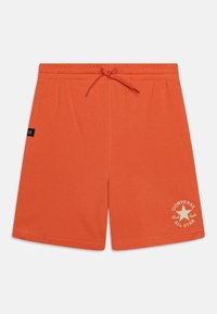 Oranžové šortky vyrobené z měkké tkaniny, s elastickým pasem na šňůrku a logem "Converse All Star" v krémové barvě.