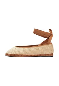 Scarpa slip-on in paglia intrecciata con punta affilata, cinturino alla caviglia in tessuto marrone e suola piatta marrone. Superficie testurizzata e fibre naturali visibili.