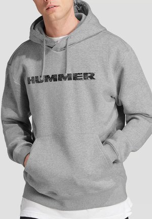 Gray hoodie crafted from soft fabric, featuring a kangaroo pocket and drawstring hood. "HUMMER" printed in bold black across the chest.