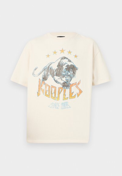 Kreminė trumpo rankovio marškinėlių su grafiniu dizainu, kuriame pavaizduotas riaumojantis tigro, žvaigždžių ir tekstas "KOOPLES since 2013" ryškiomis akcentais.