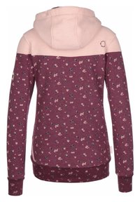Felpa con cappuccio caratterizzata da una parte superiore di un morbido rosa e una parte inferiore di un oscuro color marrone bordeaux, decorata con piccoli motivi floreali. Maniche lunghe e polsini a coste.