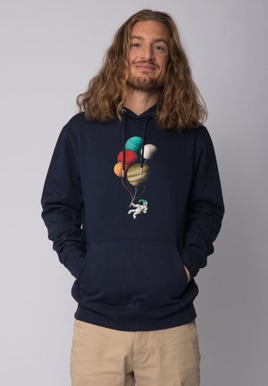 Navy hoodie featuring a graphic of an astronaut holding colorful planet balloons, with drawstrings and a front pocket. Soft material.