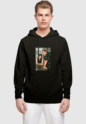Black hoodie featuring a front graphic print of two figures from a television series. Soft fabric with a relaxed fit and front pocket.