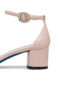 Pink leather sandal with a block heel, ankle strap, and a crystal-embellished buckle. Features a blue accent on the sole.