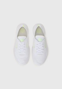 White athletic shoes with a breathable mesh upper, featuring neon green accents and a patterned insole. Rounded toe and lace closure.