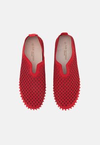 Scarpe rosse slip-on realizzate in materiale perforato, con una superficie texturizzata e dettagli in gomma arrotondati sulla suola per una migliore aderenza.
