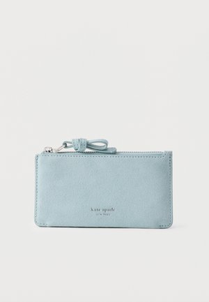 Helehall sinine seemisnahast lukuga randmekott nööriga ja ees „kate spade new york“ kaubamärgiga.