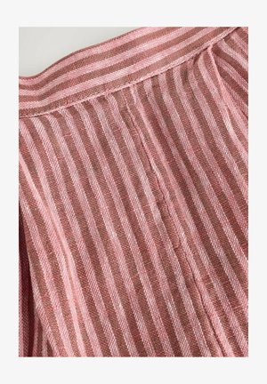 Textile fabric in pink and brown stripes. The fabric features a textured weave with visible stitching along the hem.