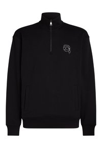 Sudadera negra con cuello alto, cremallera de medio frente y un pequeño gráfico blanco en el lado izquierdo del pecho. Presenta puños y dobladillo acanalados.