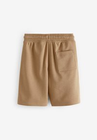 Pantalones cortos color canela hechos de material texturizado, con una cinturilla elástica y un solo bolsillo trasero. Corte recto con bordes dobladillos.