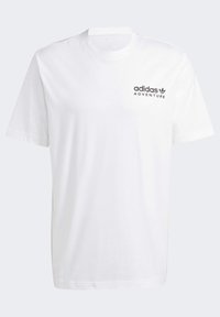 Camiseta de algodón blanca con mangas cortas, cuello redondo y un logo negro "adidas ADVENTURE" impreso en el lado izquierdo.