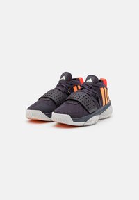 Black and orange athletic shoes with a mesh upper, perforated side panels, adjustable strap, and textured rubber sole.