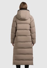 Beige long puffer coat with a hood, quilted sections, and a smooth texture. Features a black collar and zippers at the hem.