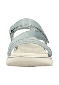Light blue adjustable sandals with two crisscross straps, textured footbed, and a white cushioned sole. Suitable for casual wear.