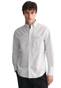 Camicia a maniche lunghe azzurro chiaro e bianco a righe, con taschino frontale e piccolo logo sul petto; in cotone.