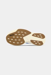 Suola di scarpa con sezioni in gomma marrone antiscivolo e base bianca, con logo Continental sulla parte anteriore della suola.