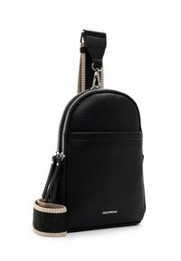 Black leather backpack with a smooth, textured finish, rounded shape, silver hardware, and a contrasting beige strap featuring a pattern.