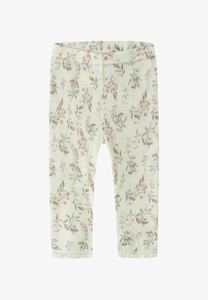 Leggings pour bébé de couleur crème avec imprimé floral rose et vert et bordure en dentelle aux chevilles.