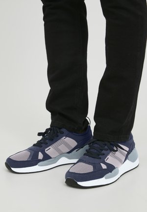Navy and grey athletic shoes with mesh and suede materials. Features a textured pattern, white sole, and black laces.