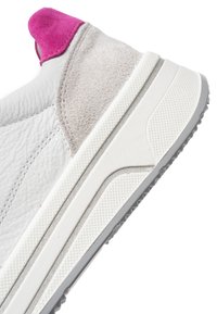White leather sneaker heel with light gray suede panel and bright pink fabric heel tab, featuring a textured white rubber sole.
