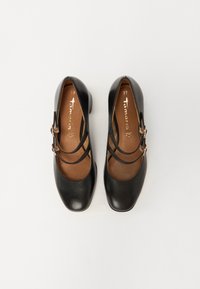 Scarpe Mary Jane in pelle nera con due cinture strette, punta tonda e tacco basso. L'interno presenta una soletta marrone con marchio. Taglia 37.