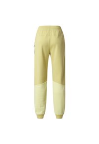 Jasnożółte spodnie dresowe z elastycznym pasem, prążkowanymi mankietami i pikowanymi panelami z tkaniny na dolnych partiach nóg, pokazane od tyłu.