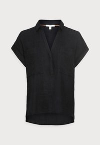 Svart linne kortärmad skjorta med V-ringning, två framfickor och en något rundad nederkant. Strukturerad tyg med en avslappnad passform.
