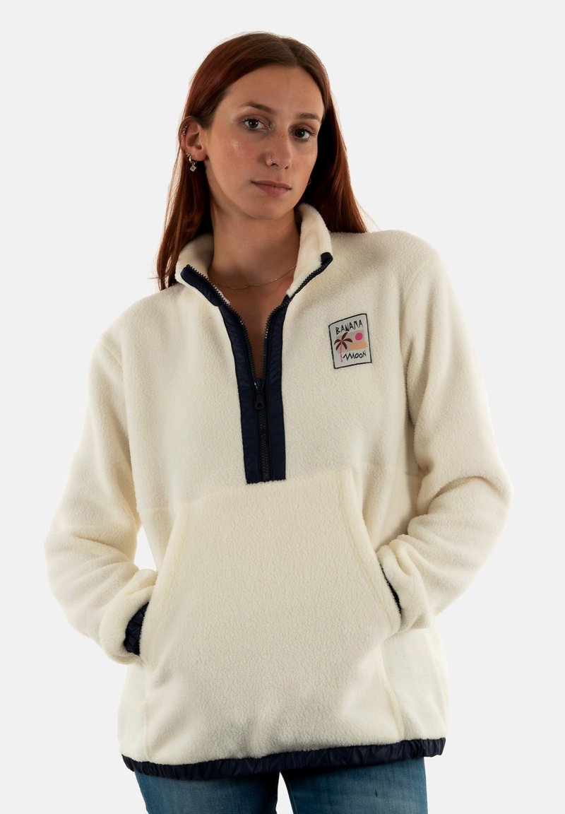 Pullover in pile bianco con zip e orlo navy, dotato di una tasca frontale e di un patch decorativo con design di palma e sole.