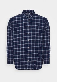 Camicia in flanella a quadri navy con controlli bianchi e rossi, maniche lunghe, chiusura a bottoni e colletto classico. Tessuto di qualità con una texture morbida.
