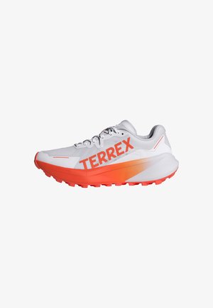 White running shoe with orange accents and "TERREX" logo. Lightweight mesh upper, cushioned sole, and textured rubber outsole for traction.