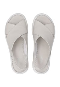 Světlé šedé kožené slip-on boty s křížovým designem, bílou gumovou podešví a odhalenými švy podél okrajů.