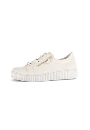 Cream-colored casual sneaker with thick ridged sole, side zipper, and lace-up front with gold-toned hardware, isolated on white background.