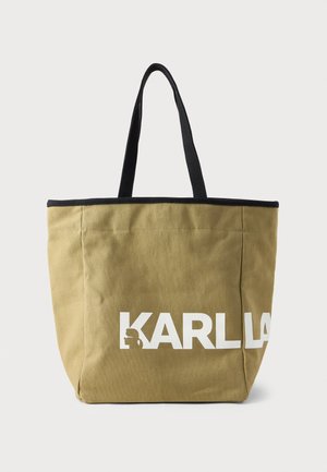 Khaki canvas tote bag with black handles, featuring a bold white "KARLL" logo and side graphic. Rectangular shape and sturdy construction.