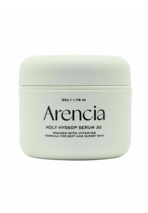 Vaso bianco di Arencia Holy Hyssop Serum 30, 50 g, etichettato come formula ricca di vitamine per una pelle morbida e luminosa.