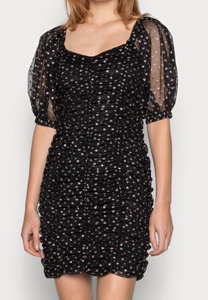 Black ruched dress with sheer puff sleeves, adorned with silver floral patterns. Features a square neckline and textured fabric.