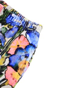 Colorful floral-patterned fabric with an elastic waistband, featuring shades of blue, pink, and green. Small black logo tag visible.
